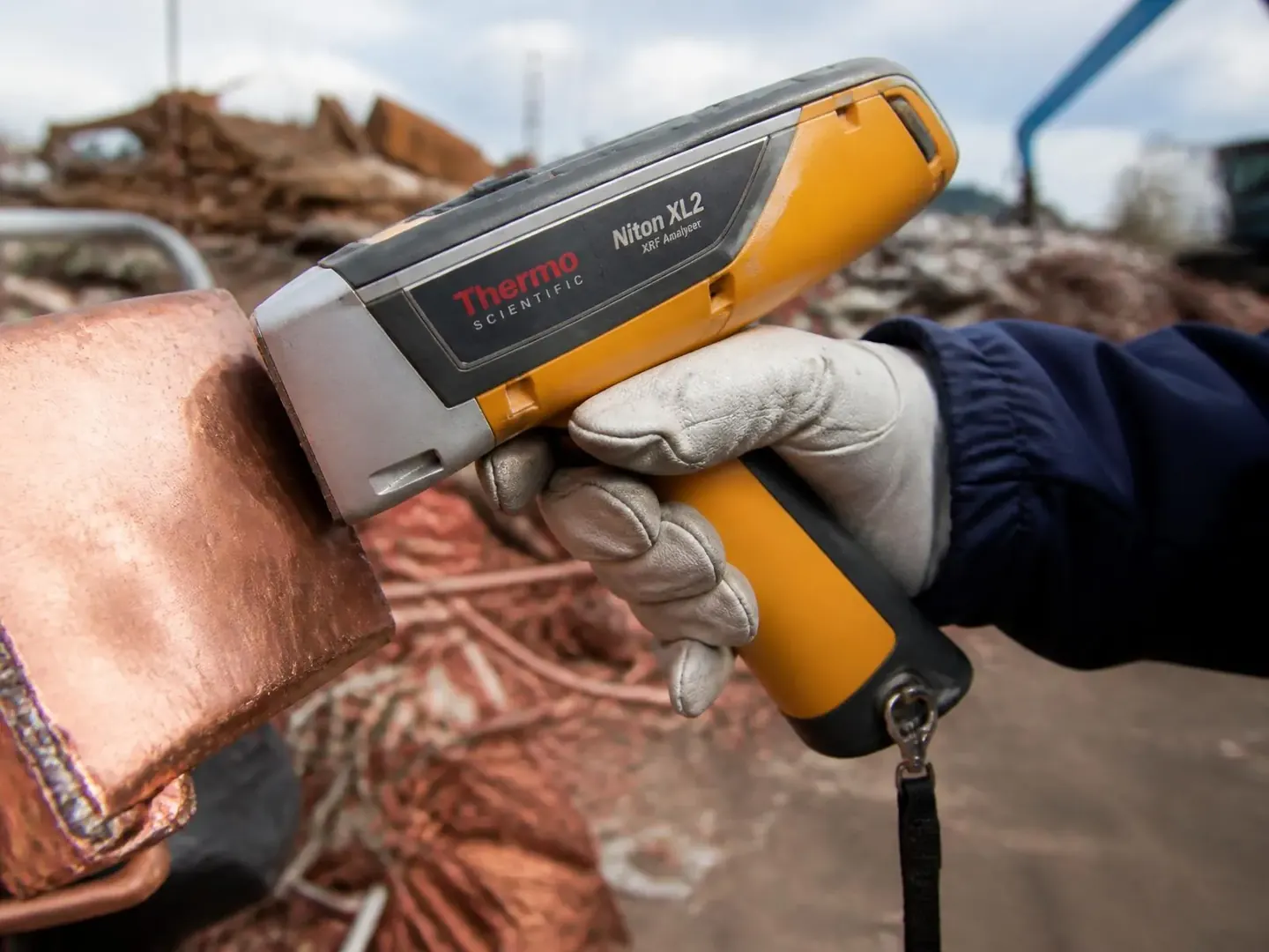 Handheld XRF analyser identifying metal grade on site